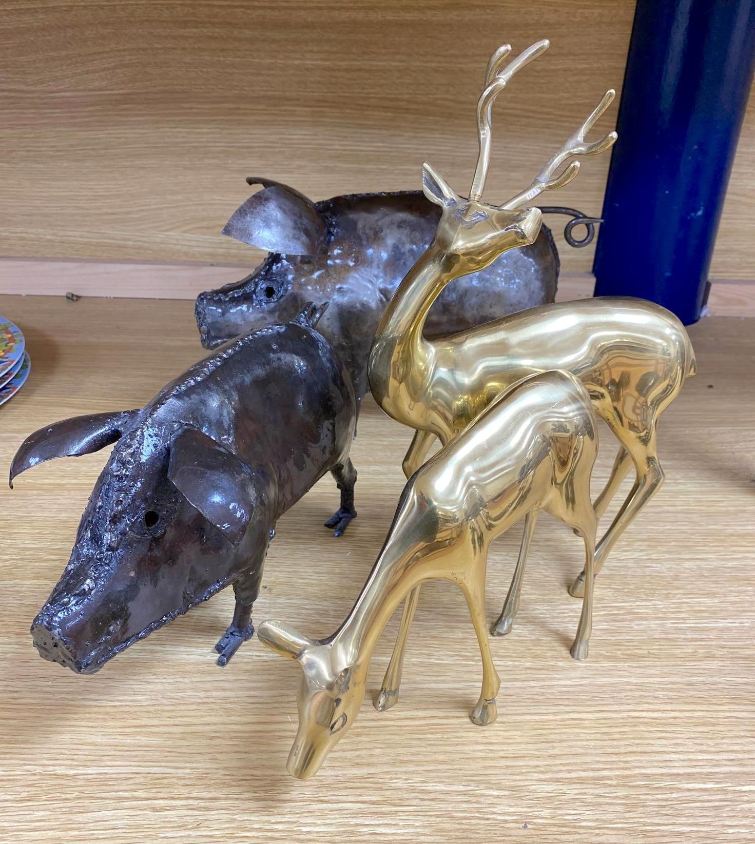 A pair of wrought iron models of pigs